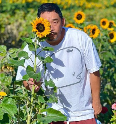 David Choe Posing With Sunflower